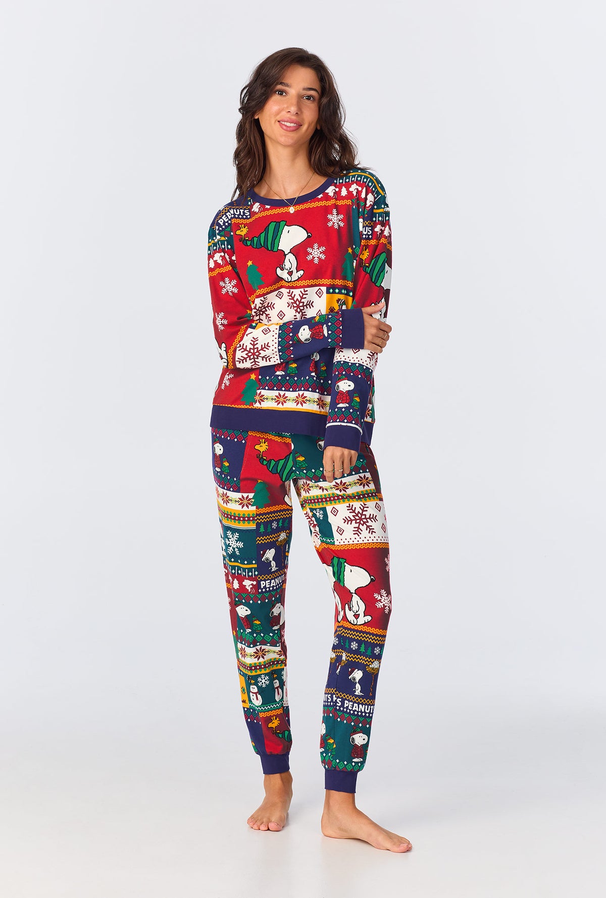 A lady wearing Fairisle Snoopy® Long Sleeve Pullover Crew and Jogger Stretch Jersey PJ Set