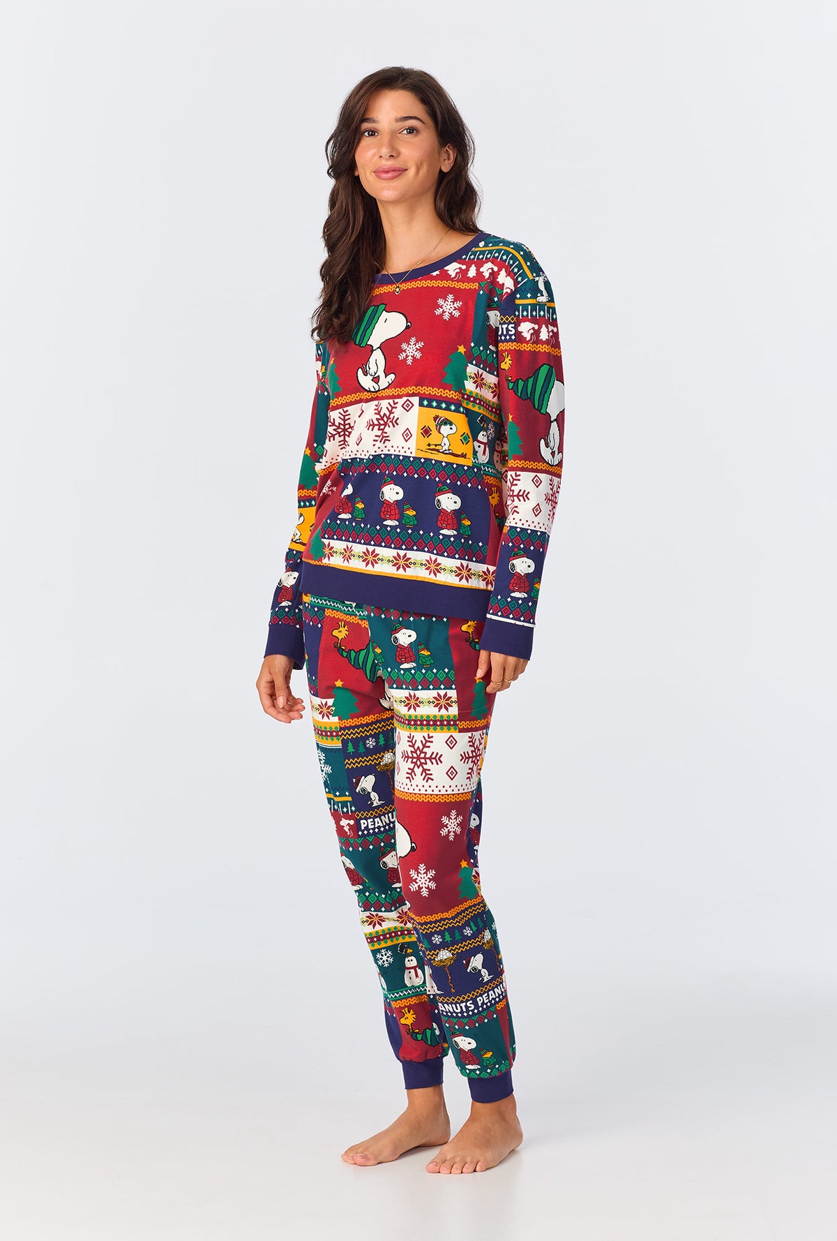 A lady wearing Fairisle Snoopy® Long Sleeve Pullover Crew and Jogger Stretch Jersey PJ Set