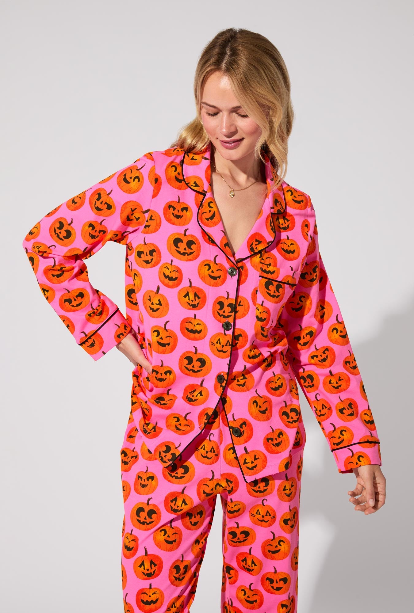 A lady wearing Jolly Jack-O-Lanterns Long Sleeve Classic Stretch Jersey PJ Set