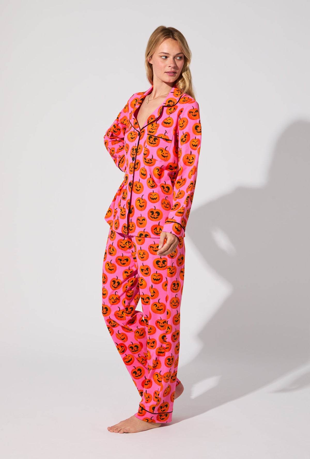 A lady wearing Jolly Jack-O-Lanterns Long Sleeve Classic Stretch Jersey PJ Set