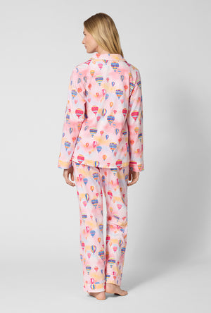 A Lady Wearing Serene Sunrise Long Sleeve Classic Stretch Jersey Pj Set in a back view pose