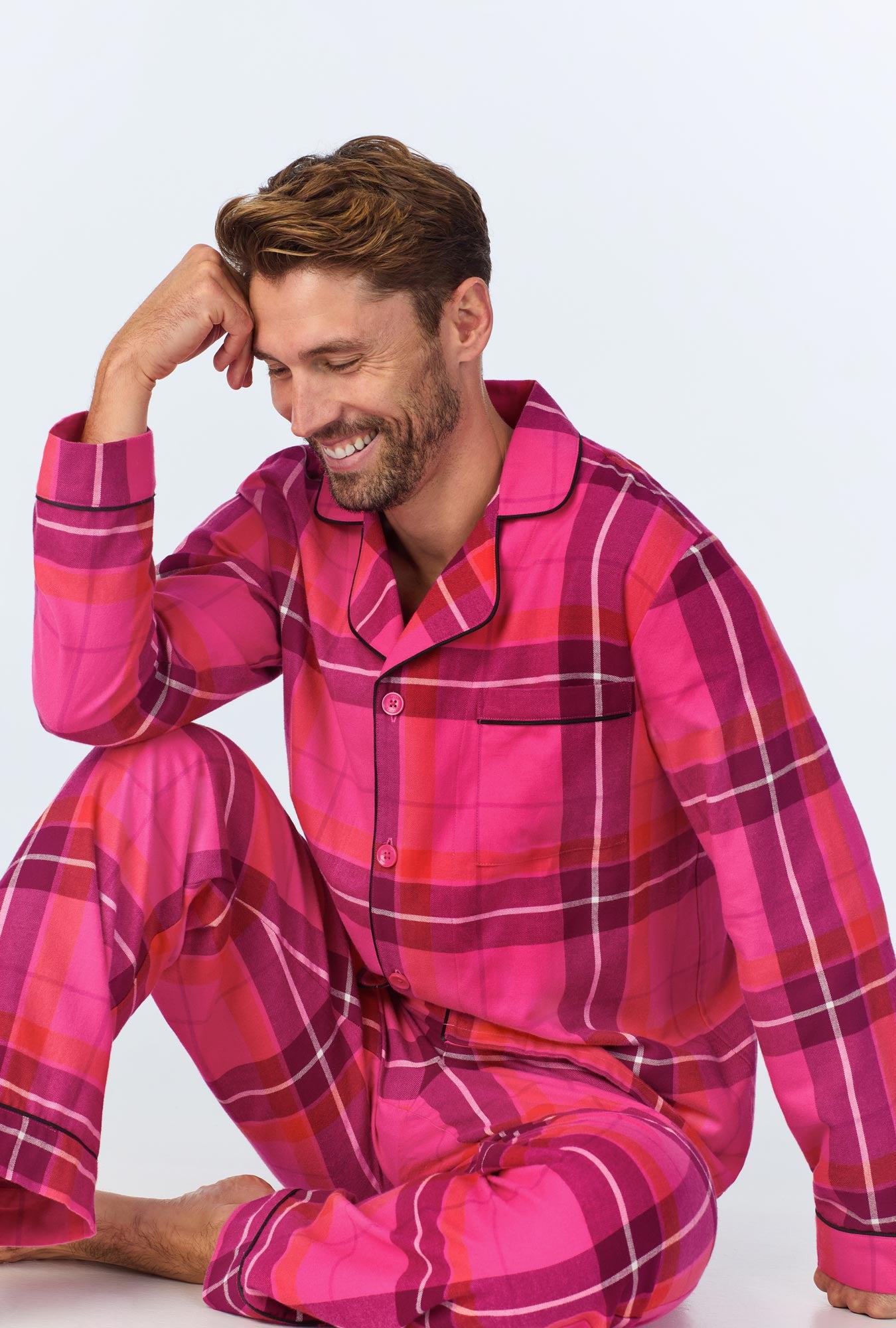 A man wearing a  Aurora Plaid Men's Long Sleeve Classic Woven Portuguese Flannel PJ Set