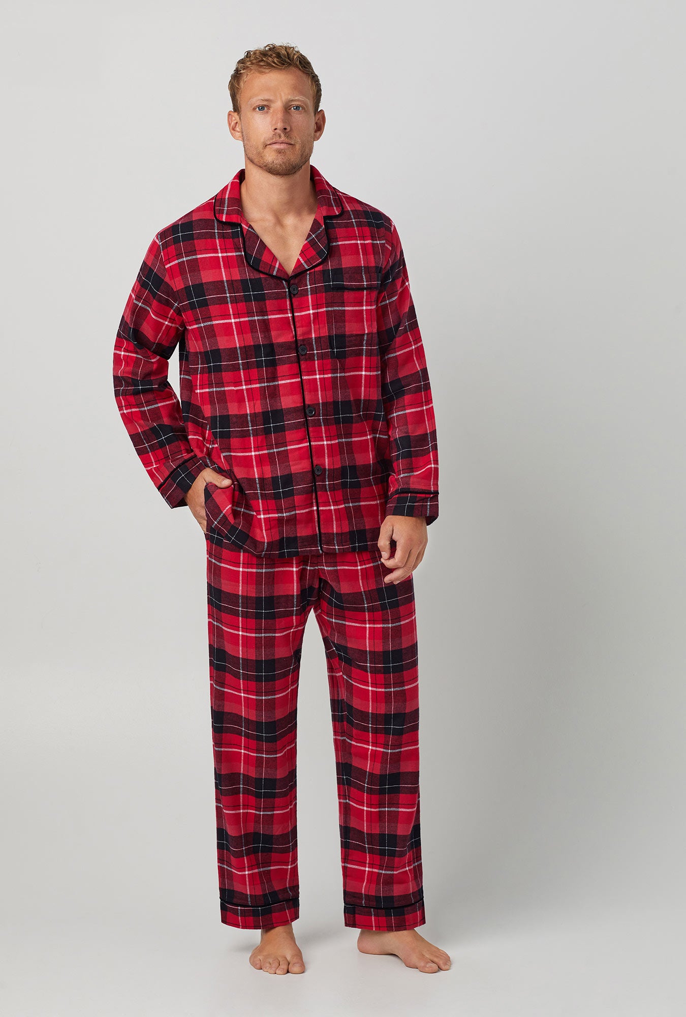 A man wearing a red long sleeve classic woven cotton flannel pj set with nicholas plaid print.