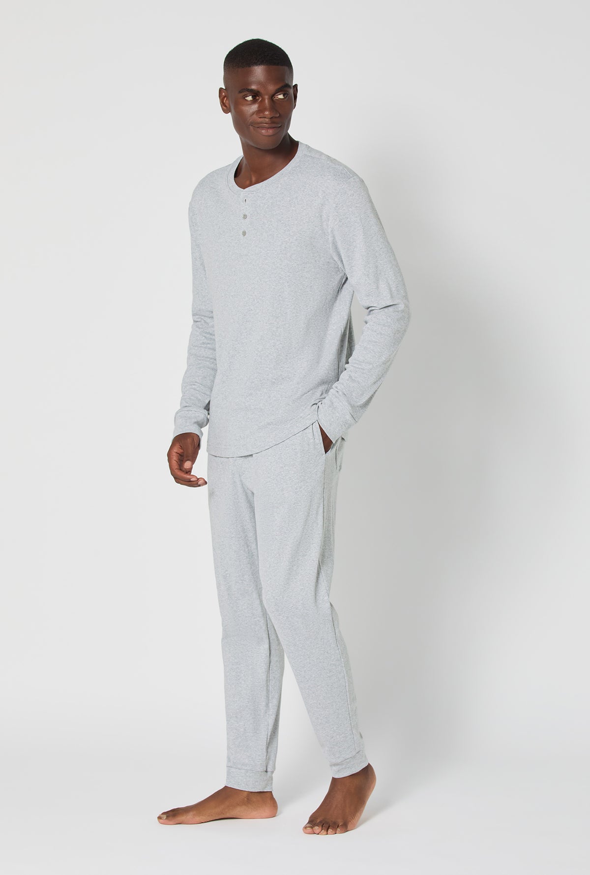 A man wearing True Grey Heather Men's Long Sleeve Henley And Jogger Cotton Rib Pj Set