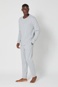 A man wearing True Grey Heather Men's Long Sleeve Henley And Jogger Cotton Rib Pj Set