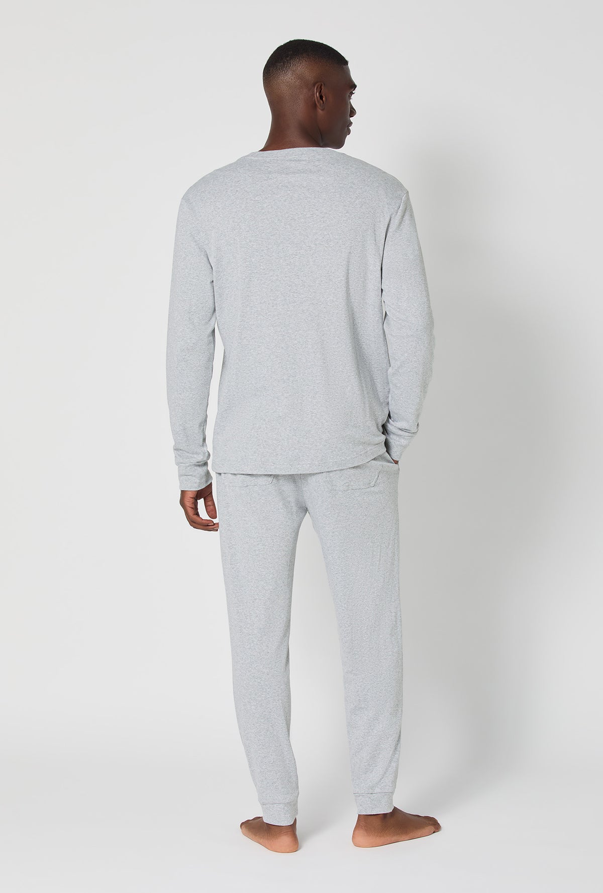 A man wearing True Grey Heather Men's Long Sleeve Henley And Jogger Cotton Rib Pj Set