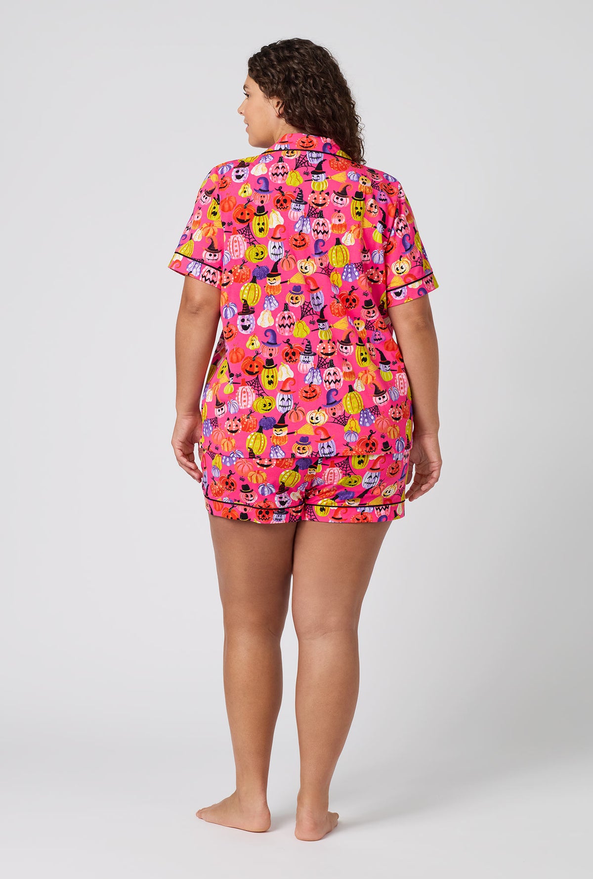 A Lady Wearing Plus Size Pumpkin Patch Party Short Sleeve Classic Shorty Stretch Jersey Pj Set in a back view pose