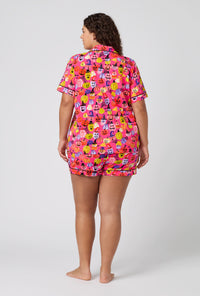 A Lady Wearing Plus Size Pumpkin Patch Party Short Sleeve Classic Shorty Stretch Jersey Pj Set in a back view pose
