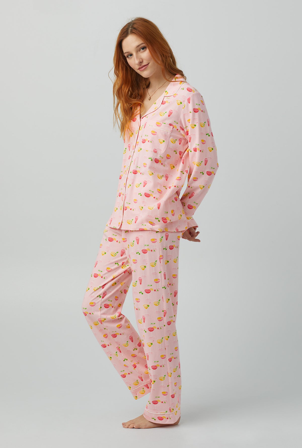 A lady wearing pink Long Sleeve Classic Stretch Jersey PJ Set with Pink Mixology print