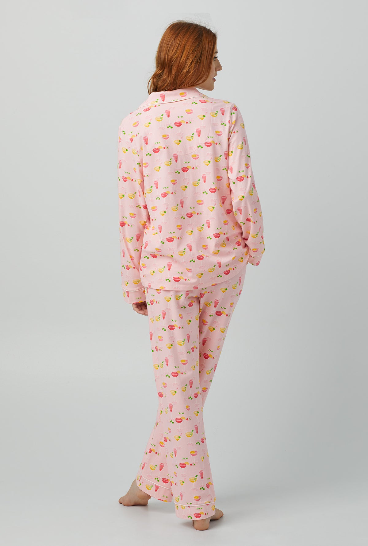 A lady wearing pink Long Sleeve Classic Stretch Jersey PJ Set with Pink Mixology print