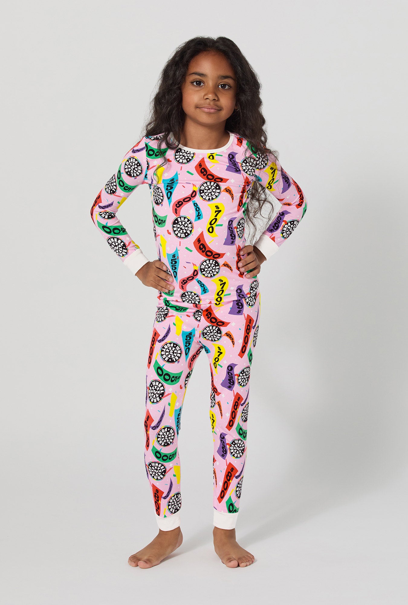 A girl wearing Spin To Win Long Sleeve Stretch Jersey Kids Pj Set