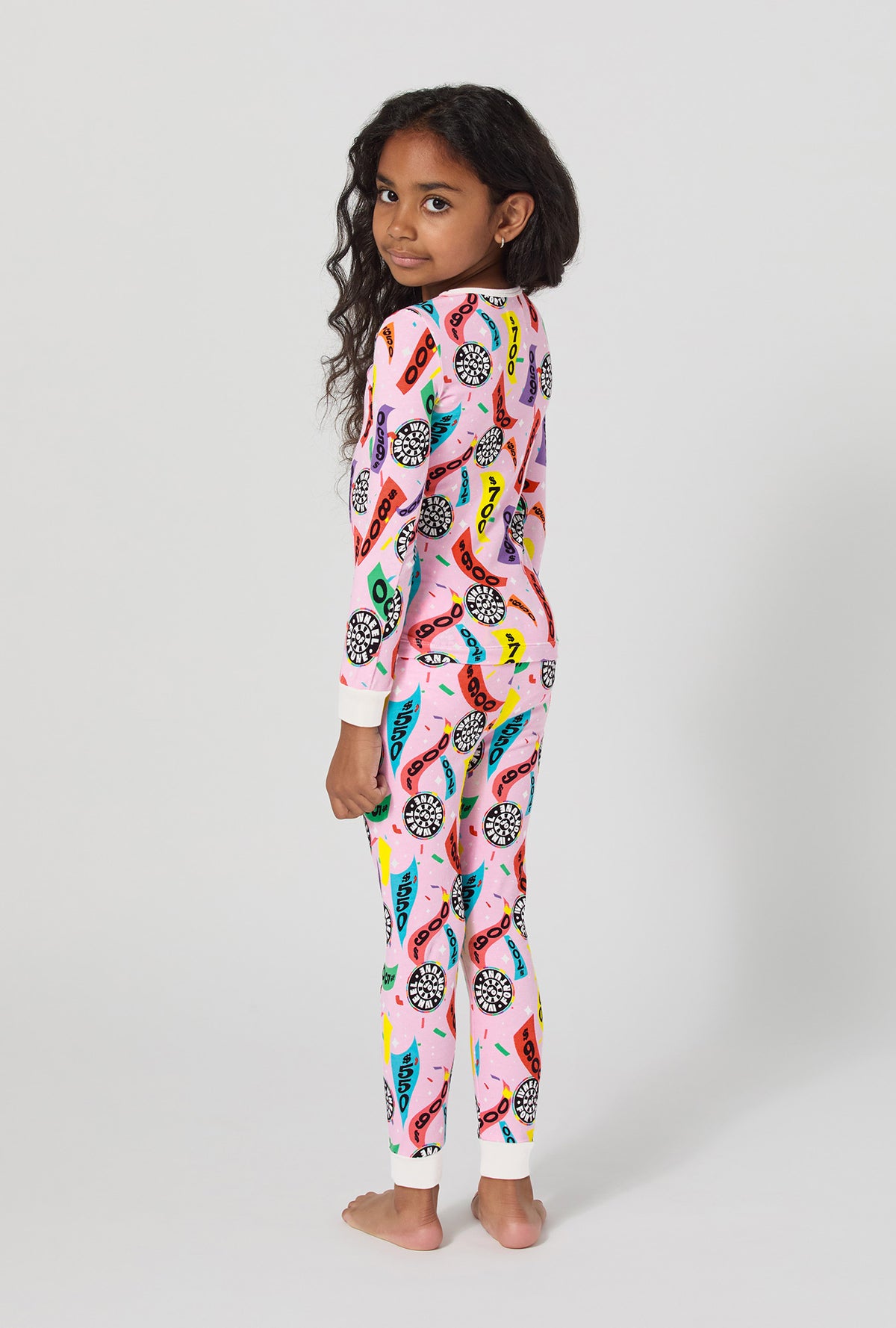 A girl wearing Spin To Win Long Sleeve Stretch Jersey Kids Pj Set