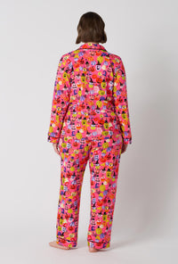 A Lady Wearing Plus Size Pumpkin Patch Party Long Sleeve Classic Stretch Jersey Pj Set in a back view pose