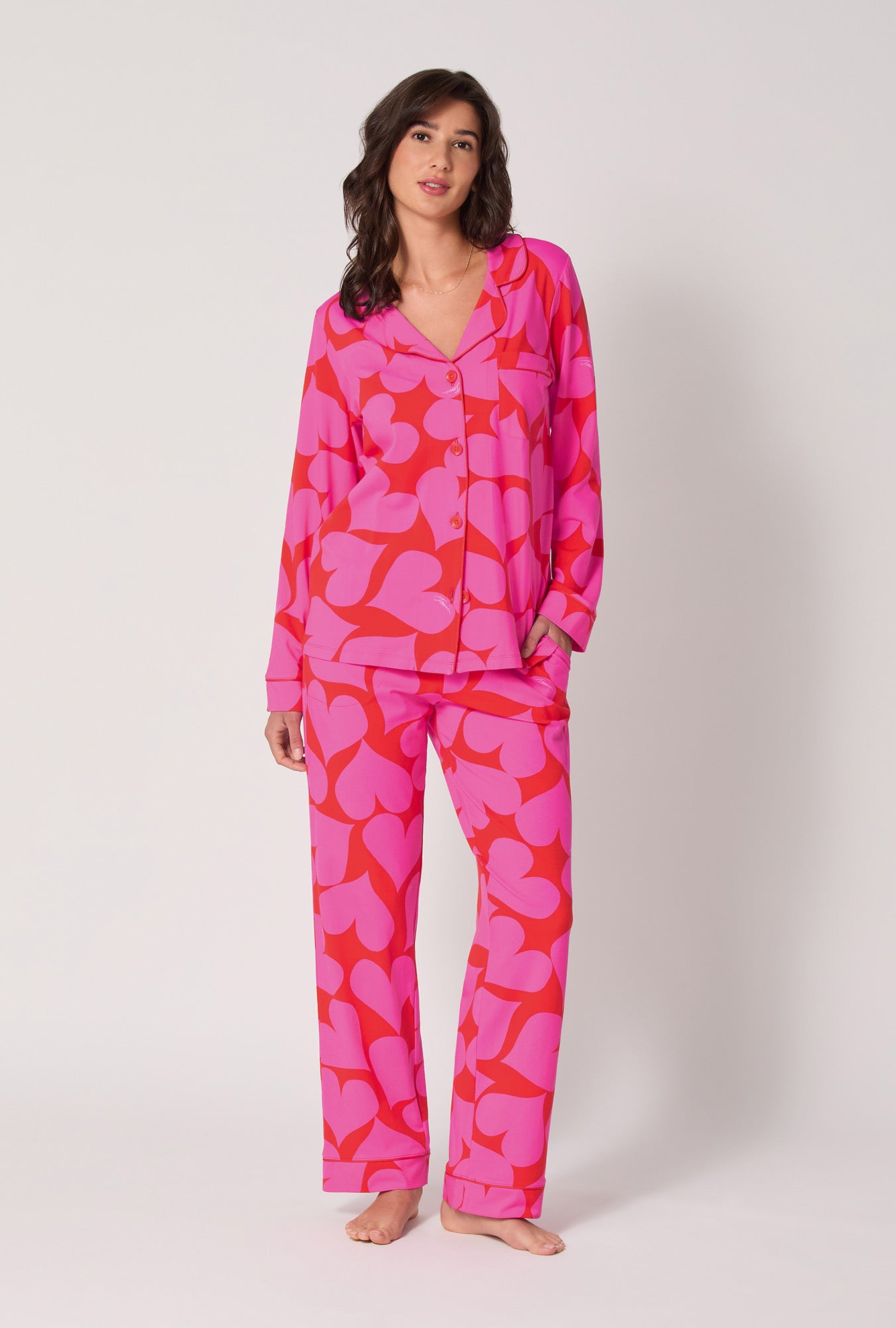 A lady wearing BedHead x Trina Turk Hearts Long Sleeve Classic Stretch Jersey Pj Set
