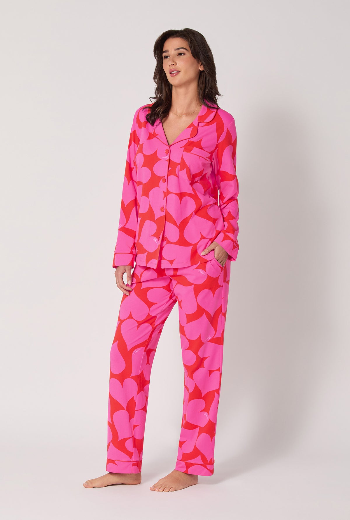 A lady wearing BedHead x Trina Turk Hearts Long Sleeve Classic Stretch Jersey Pj Set