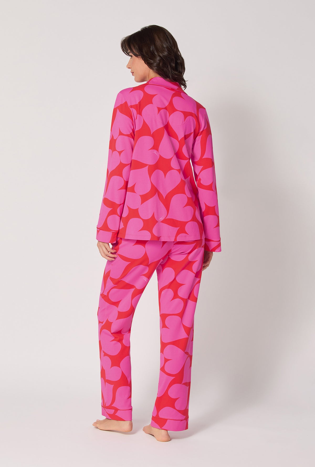 A lady wearing BedHead x Trina Turk Hearts Long Sleeve Classic Stretch Jersey Pj Set
