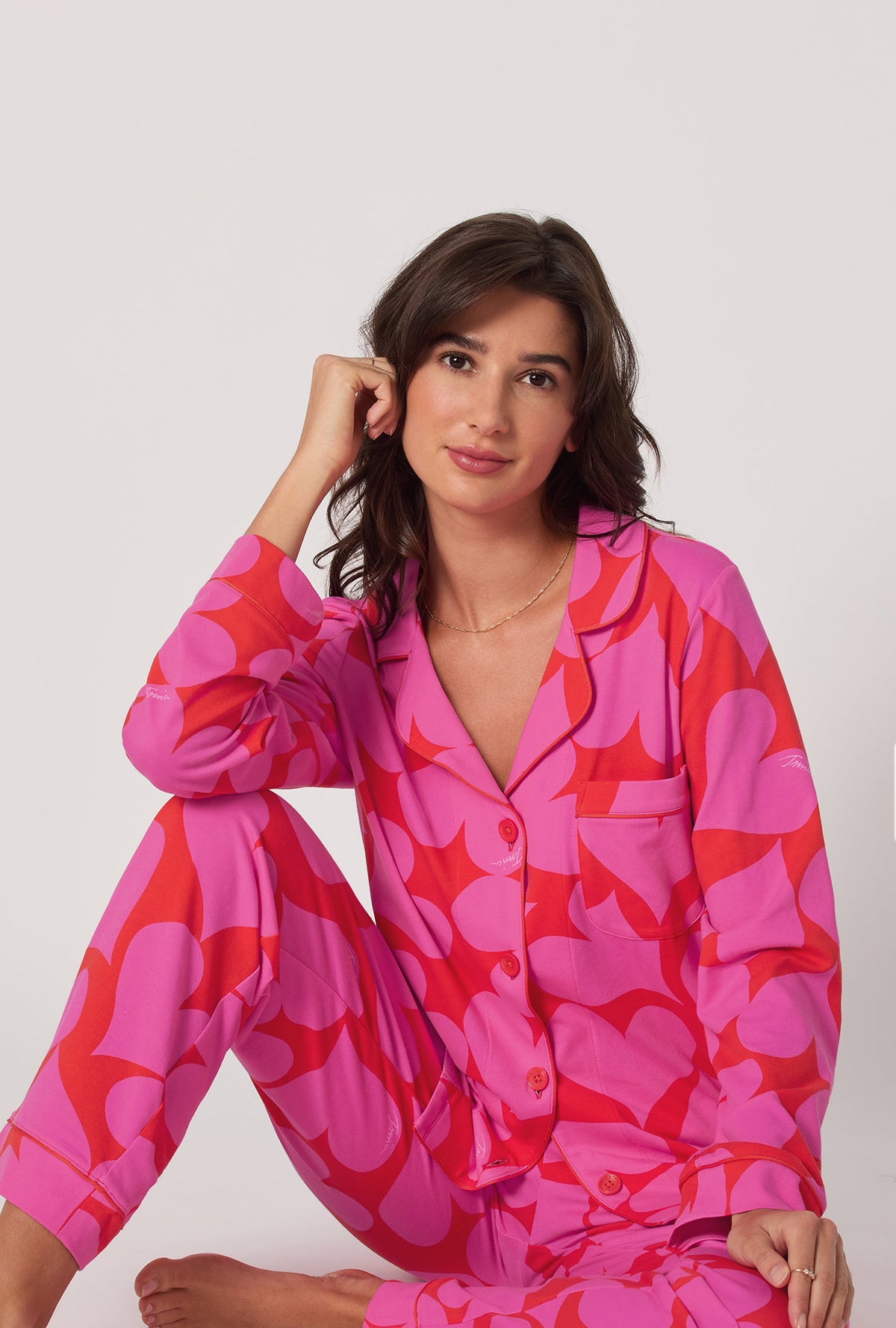 A lady wearing BedHead x Trina Turk Hearts Long Sleeve Classic Stretch Jersey Pj Set