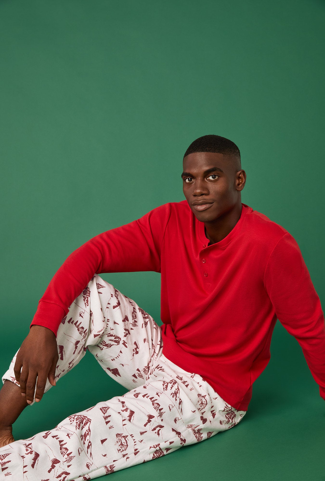 A man wearing Alpine Toile Long Sleeve Henley And Jogger Woven Portuguese Flannel PJ Set