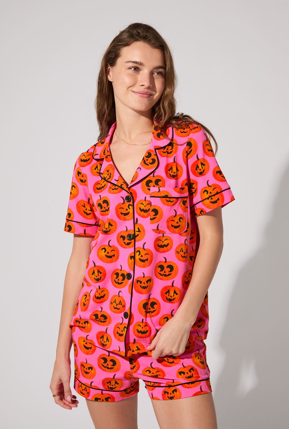 A lady wearing Jolly Jack-O-Lanterns Short Sleeve Classic Shorty Stretch Jersey PJ Set