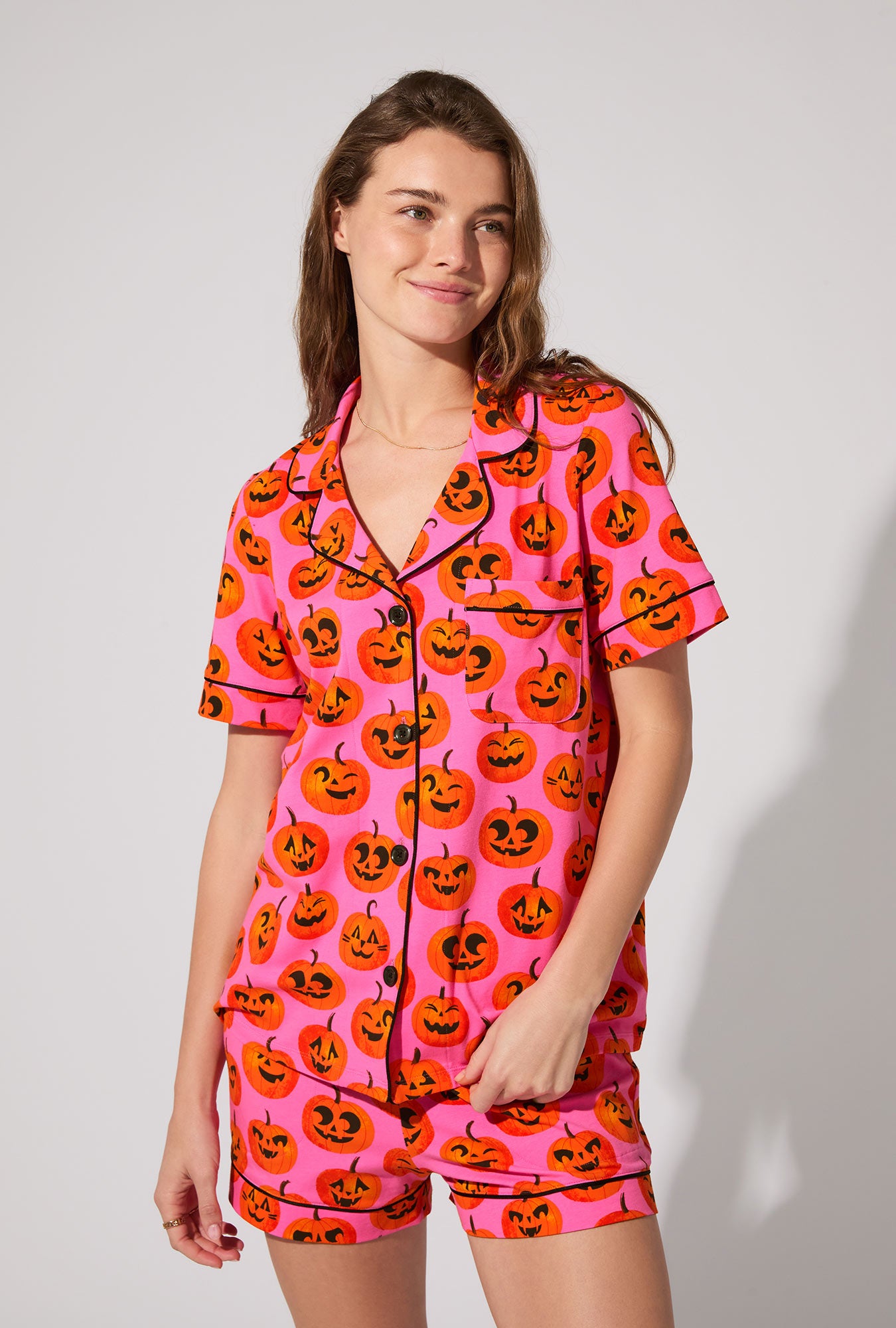 A lady wearing Jolly Jack-O-Lanterns Short Sleeve Classic Shorty Stretch Jersey PJ Set