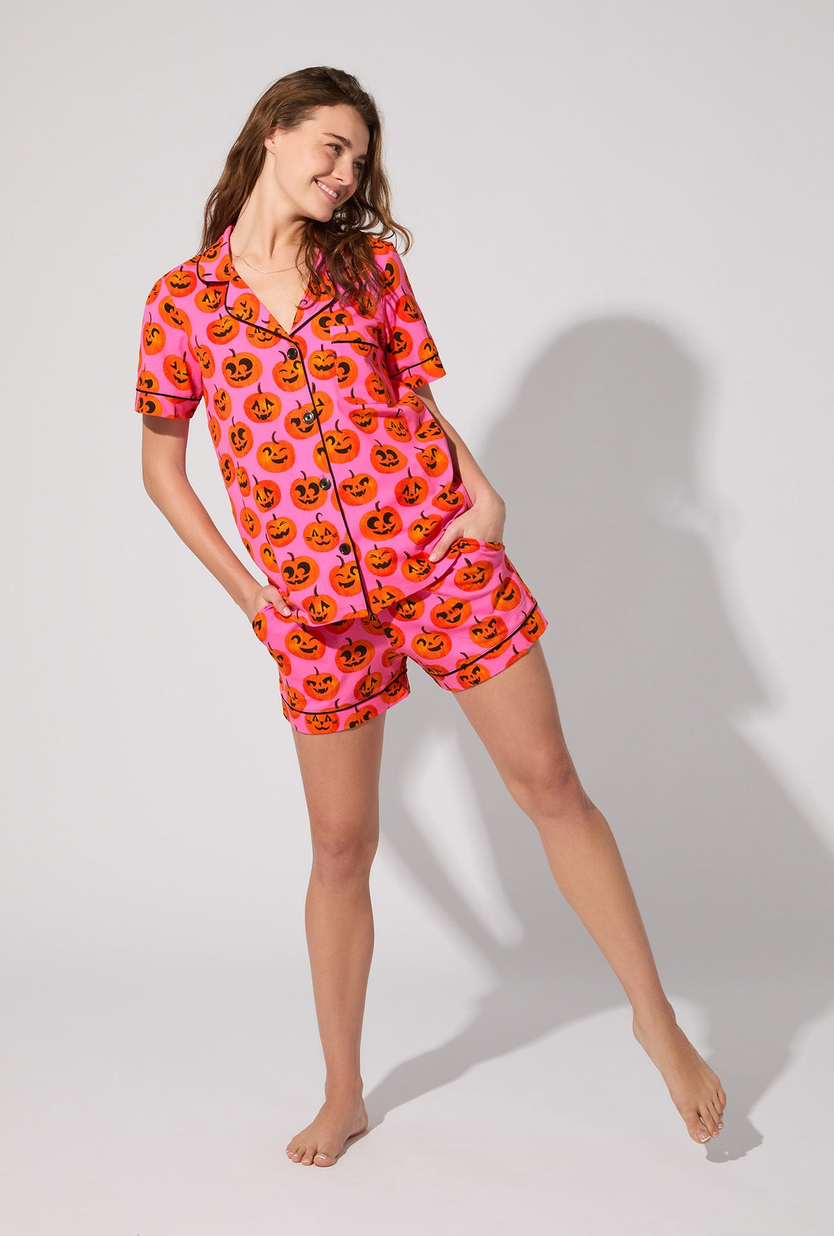 A lady wearing Jolly Jack-O-Lanterns Short Sleeve Classic Shorty Stretch Jersey PJ Set
