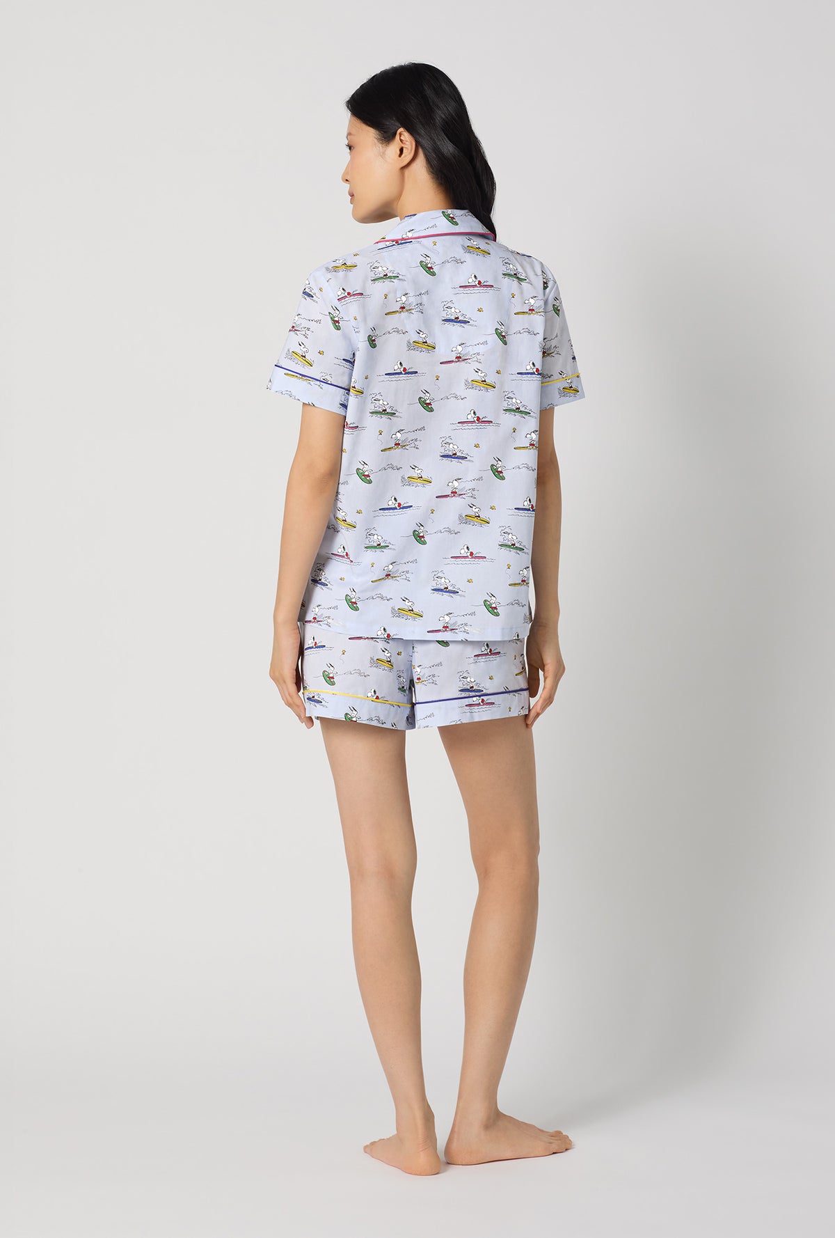 A lady wearing Catch A Wave, Snoopy Short Sleeve Classic Woven Cotton Poplin Shorty Pj Set back view