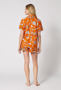 A Lady Wearing Orange Spooky In The City Short Sleeve Classic Shorty Stretch Jersey Pj Set in a back view pose