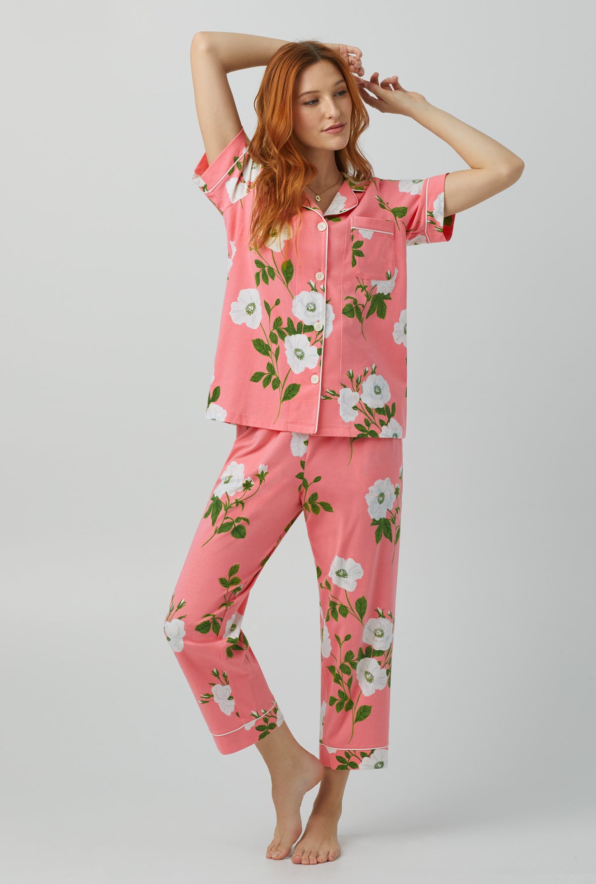 A lady wearing red Short Sleeve Classic Stretch Jersey Cropped PJ Set with White Poppy print