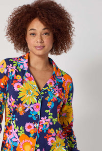 A lady wearing BedHead x Trina Turk Bay Street Bloom Long Sleeve Classic Stretch Jersey Pj Set