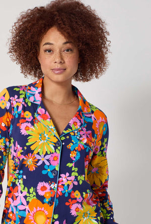 A lady wearing BedHead x Trina Turk Bay Street Bloom Long Sleeve Classic Stretch Jersey Pj Set