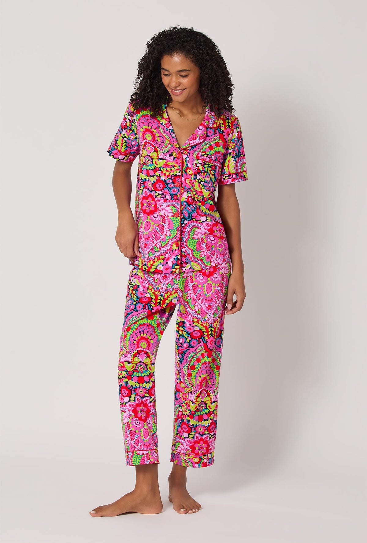 A lady wearing BedHead x Trina Turk Las Flores Short Sleeve Classic Stretch Jersey Cropped Pj Set