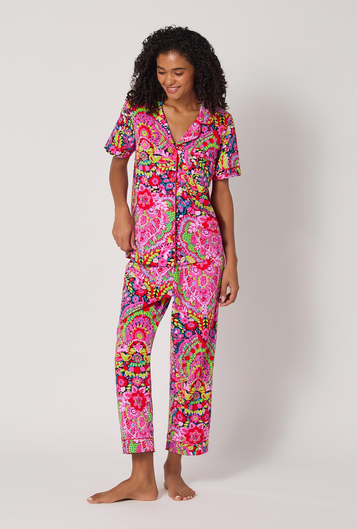 A lady wearing BedHead x Trina Turk Las Flores Short Sleeve Classic Stretch Jersey Cropped Pj Set