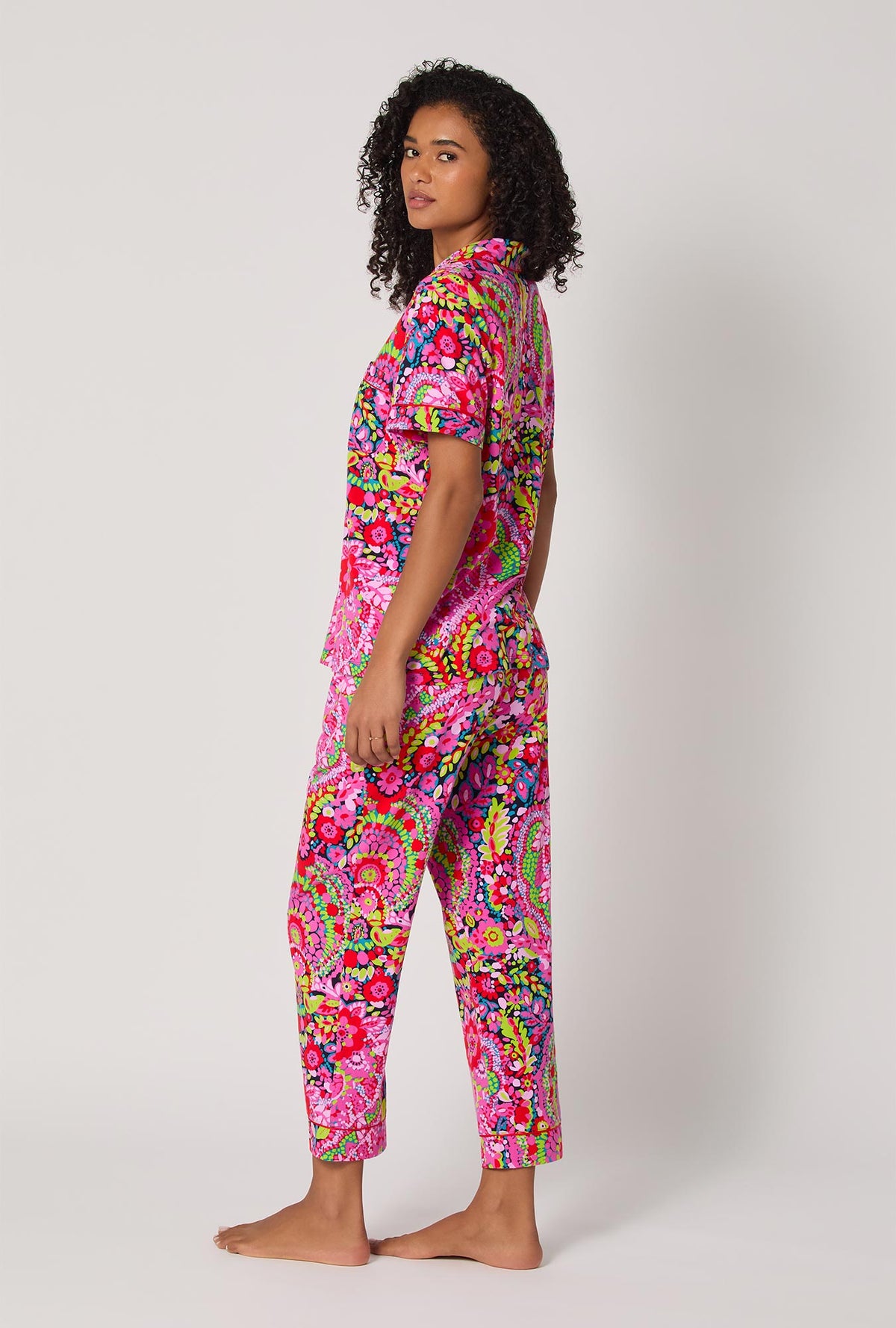 A lady wearing BedHead x Trina Turk Las Flores Short Sleeve Classic Stretch Jersey Cropped Pj Set