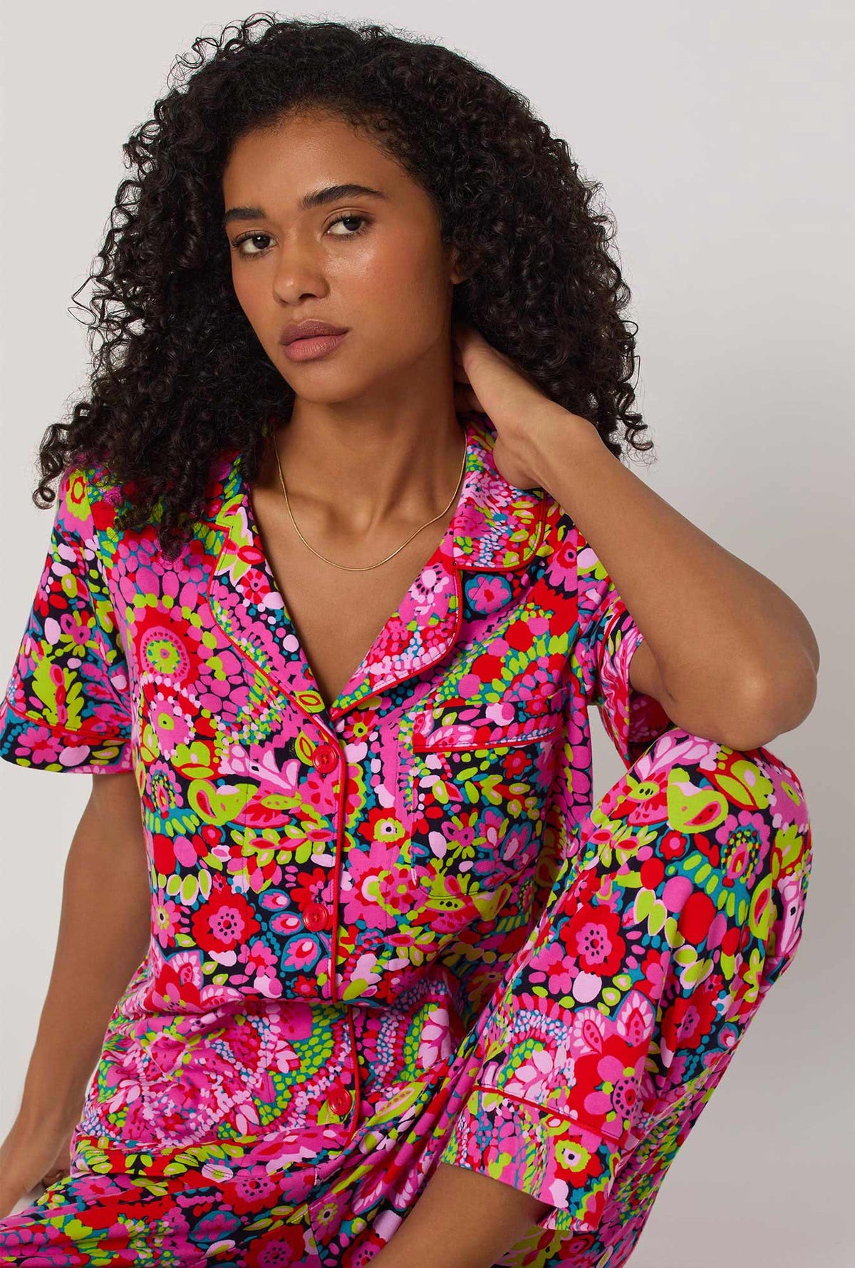 A lady wearing BedHead x Trina Turk Las Flores Short Sleeve Classic Stretch Jersey Cropped Pj Set