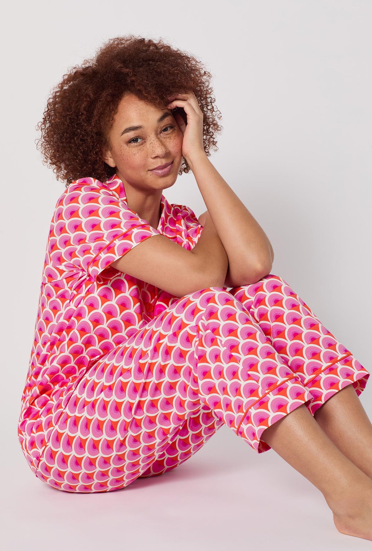 A lady wearing BedHead x Trina Turk Scallop Short Sleeve Classic Stretch Jersey Cropped Pj Set