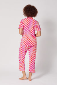 A lady wearing BedHead x Trina Turk Scallop Short Sleeve Classic Stretch Jersey Cropped Pj Set