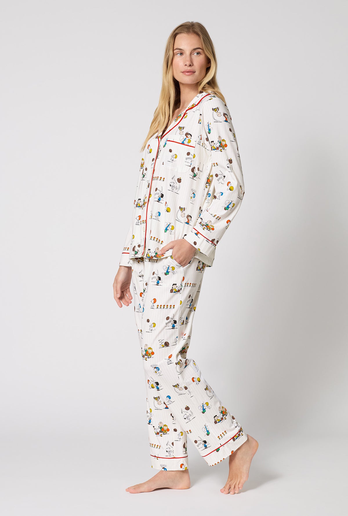 A Lady Wearing Snoopy's Game Day Long Sleeve Classic Stretch Jersey Pj Set in a side angled pose