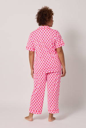 A lady wearing plus size BedHead x Trina Turk Scallop Short Sleeve Classic Stretch Jersey Cropped Pj Set
