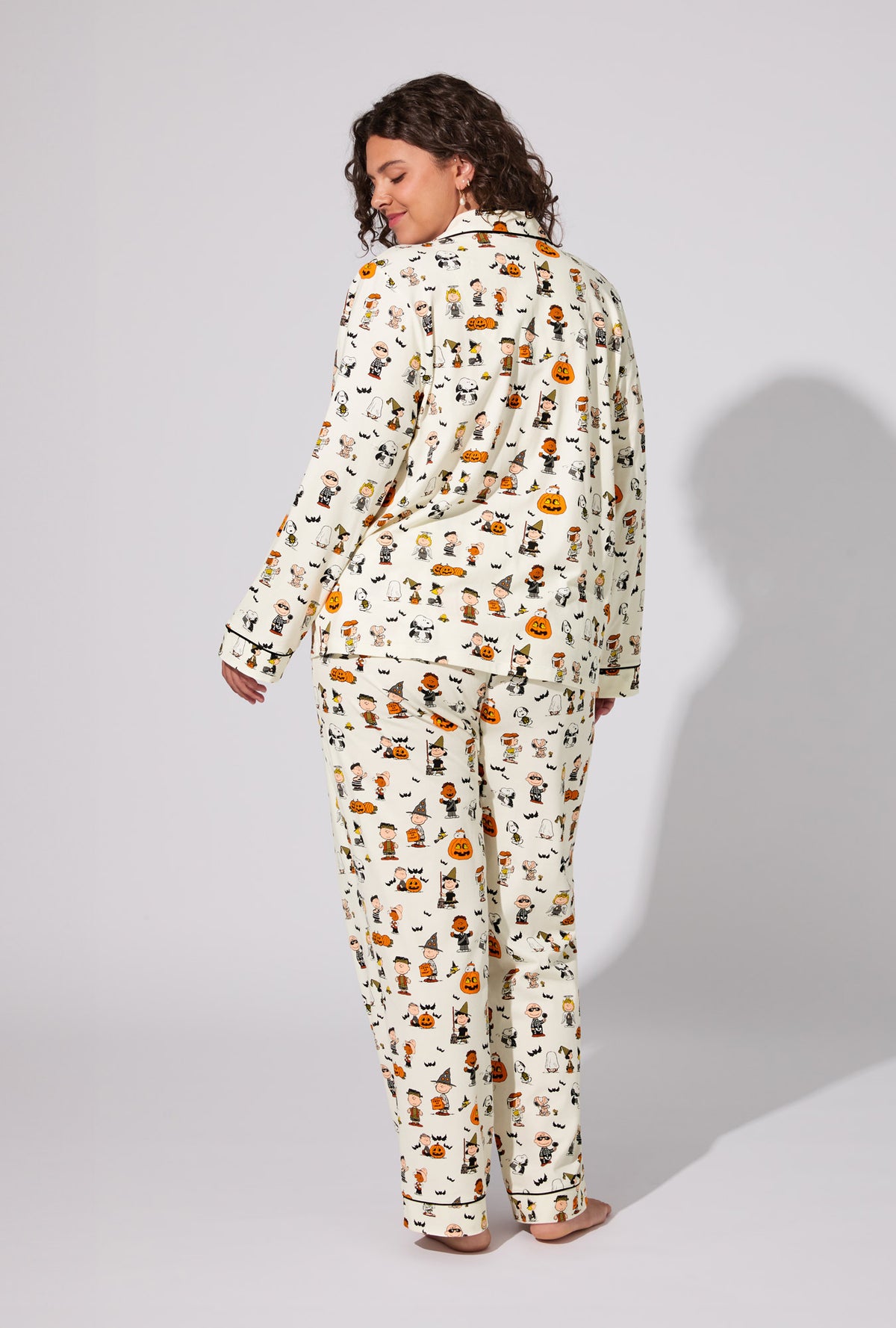 A lady wearing Peanuts® Snoopy&#39;s Halloween Long Sleeve Classic Stretch Jersey PJ Set