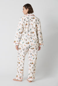 A Lady Wearing Plus Size Snoopy's Game Day Long Sleeve Classic Stretch Jersey Pj Set in a back view pose