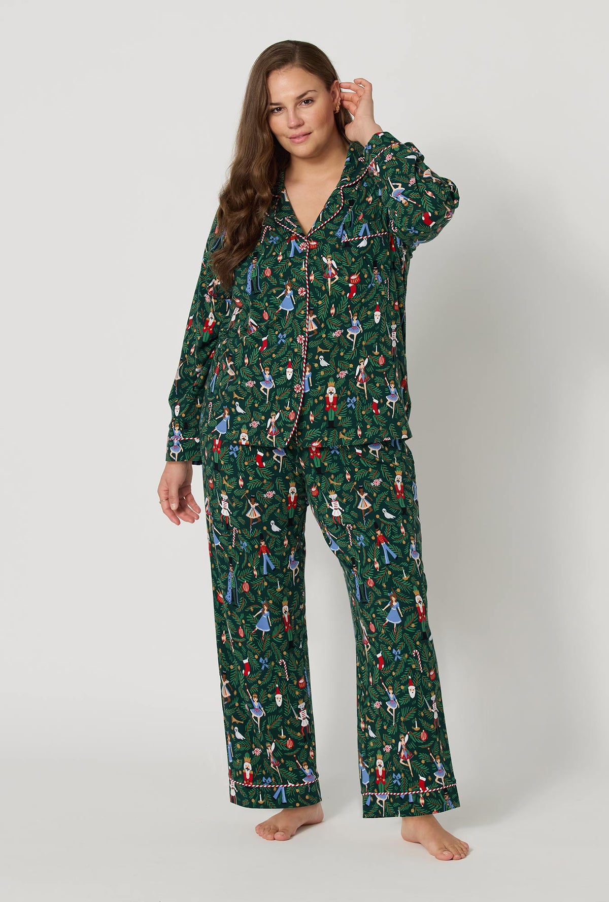 A lady wearing plus size Rifle Paper Co. x BedHead PJs Nutcracker Long Sleeve Classic Stretch Jersey Pj Set 