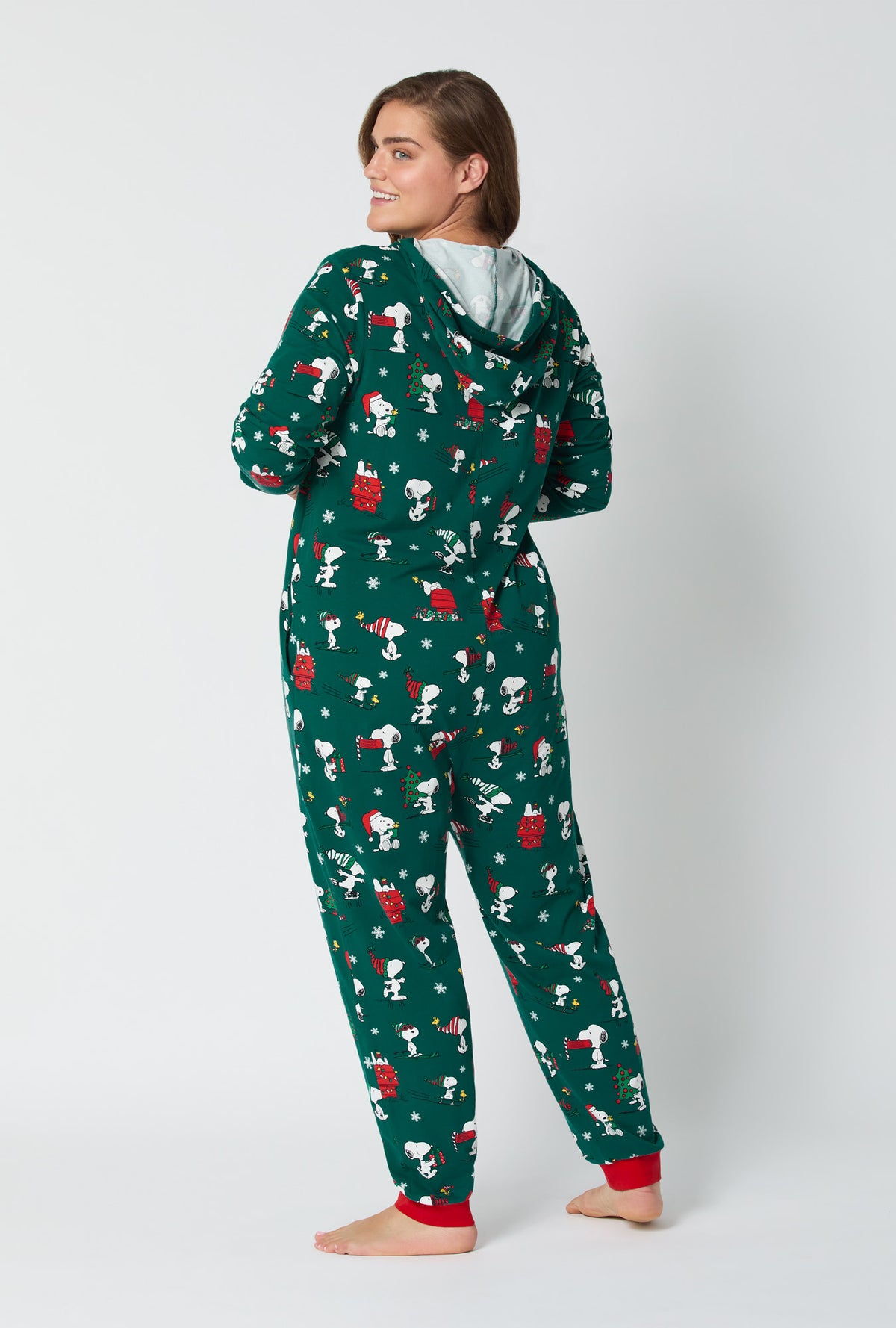 A lady wearing ®Snoopy's Holiday Fun Long Sleeve Stretch Jersey Unisex Onesie