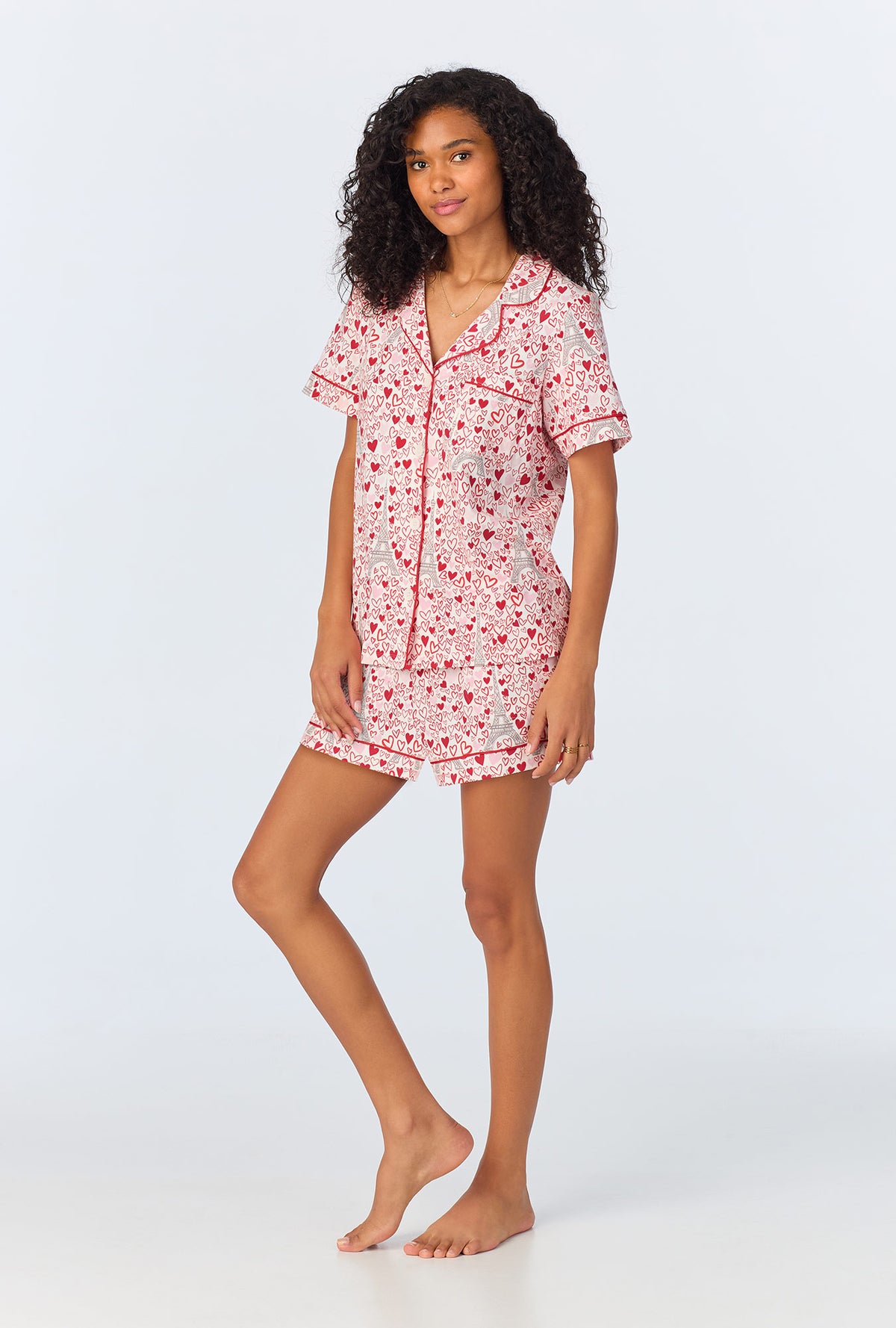 A lady wearing pink short sleeve pajama set with paris je taime print.