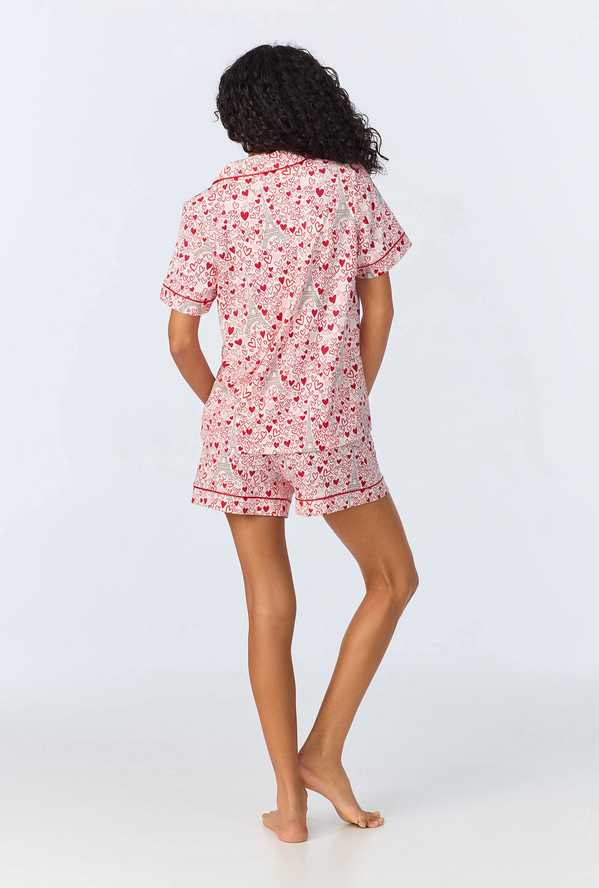 A lady wearing pink short sleeve pajama set with paris je taime print.