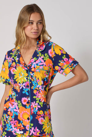 A lady wearing BedHead x Trina Turk Bay Street Bloom Short Sleeve Classic Shorty Stretch Jersey Pj Set