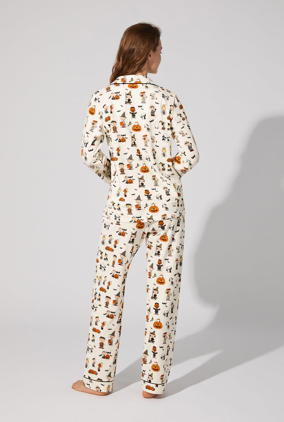 A lady wearing Peanuts® Snoopy&#39;s Halloween Long Sleeve Classic Stretch Jersey PJ Set