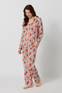 A lady wearing Rifle Paper Co. x BedHead PJs Cardinals Long Sleeve Classic Stretch Jersey Pj Set looking down