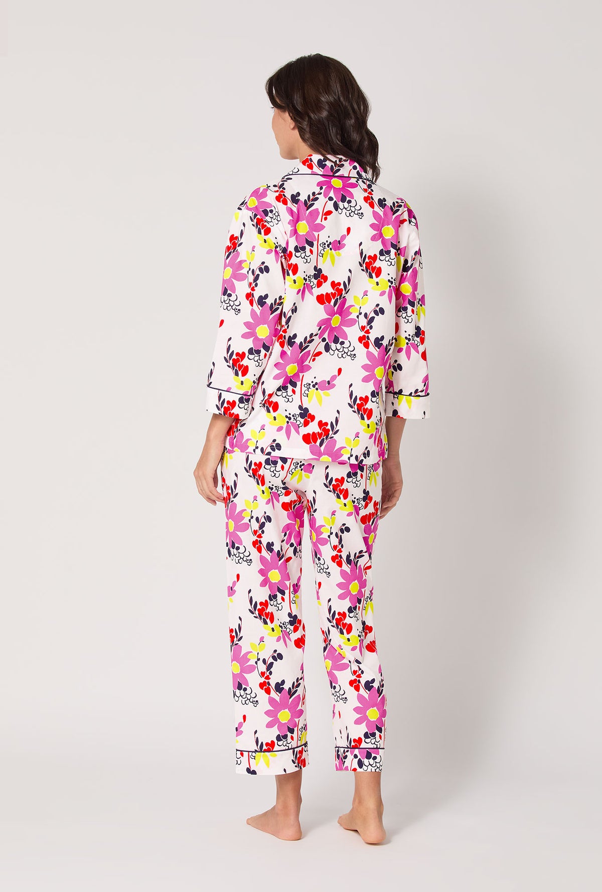 A lady wearing BedHead x Trina Turk Whimsical Floral 3/4 Sleeve Classic Woven Cotton Cropped Pj Set