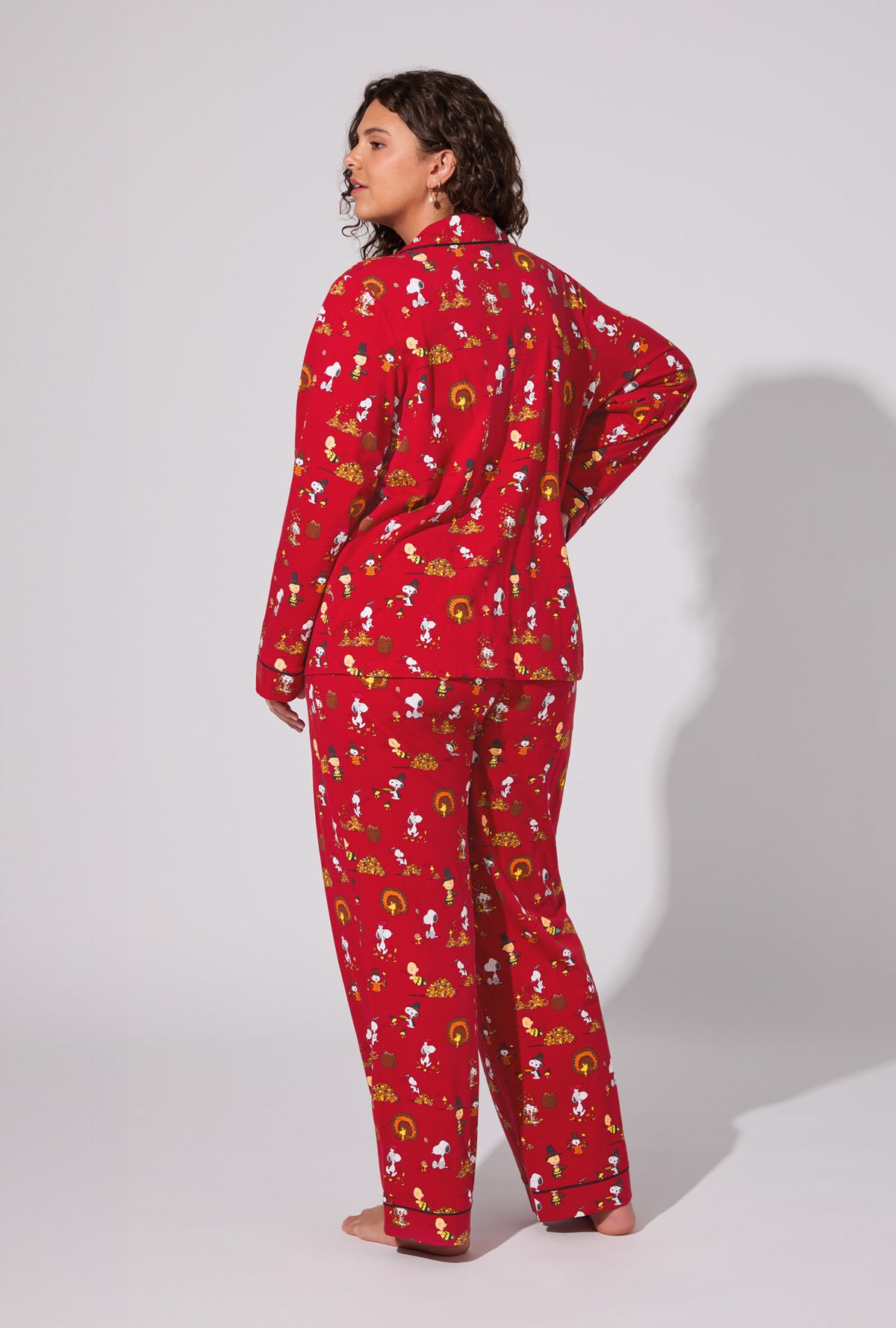 A lady wearing Peanuts® Snoopy&#39;s Thanksgiving Long Sleeve Classic Stretch Jersey PJ Set