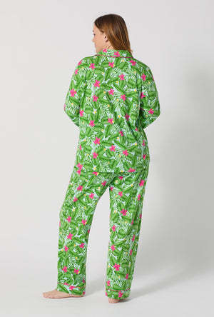 A Lady Wearing Plus Size Monstera Bloom Long Sleeve Classic Stretch Jersey Pj Set posing with a back view